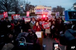 People gather to protest President Trump's new travel ban order in Lafayette Park outside the White House, March 6, 2017.