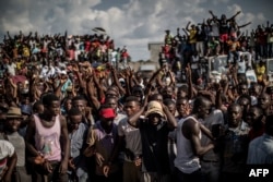 Supporters of Guy Brice Parfait Kolelas, the Interim President of the Congolese Movement for Democracy and Integral Development demonstrate at the candidate head quarter in Brazzaville on March 23, 2016.