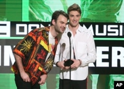 Alex Pall, left, and Andrew Taggart, of The Chainsmokers, accept the award for favorite artist - electronic dance music at the American Music Awards at the Microsoft Theater on Nov. 20, 2016, in Los Angeles.
