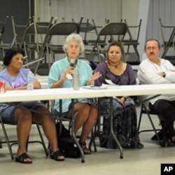 Marine biologist Riki Ott (holding microphone) has been studying the effects of the 1989 Exxon Valdez spill for the last 20 years.