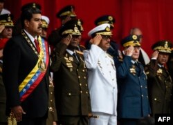 Venezuelan President Nicolas Maduro, left, and members of the military high command attend a military honor ceremony in Caracas on May 24, 2018.