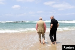 FILE - Israel's Prime Minister Benjamin Netanyahu (R) walks with India's Prime Minister Narendra Modi as they visit Olga Beach and a water desalination unit operated by G.A.L. Water Technologies, near Hadera, Israel, July 6, 2017.