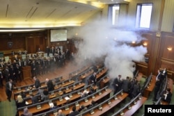 Opposition politicians release tear gas in parliament to obstruct a session in Pristina, Kosovo, Feb. 19, 2016.