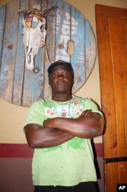 Although he prefers cooking, the muscular Aaron Kalimanjira works as a doorman when the Kaapsche Hoop bar turns into a nightclub on weekends