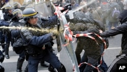 Policemen clash with activists during a protest ahead of the 2015 Paris Climate Conference at the place de la Republique, in Paris, France, Nov. 29, 2015.