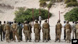 Hassan Hanafi Haji is tied to a wooden post as he is prepared to be executed by firing squad at a police academy in the capital Mogadishu, Somalia Monday, April 11, 2016.