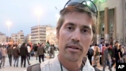 FILE - This undated file still image from video released April 7, 2011, by GlobalPost, shows James Foley of Rochester, N.H., a freelance contributor for GlobalPost, in Benghazi, Libya.