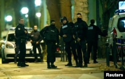 French special police forces secure the area as shots are exchanged in Saint-Denis, France, near Paris, Nov. 18, 2015.