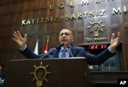 Turkey's President Recep Tayyip Erdogan gestures as he deliver a speech to members of his ruling Justice and Development Party (AKP), during its weekly meeting in Ankara, Turkey, May 8, 2018.