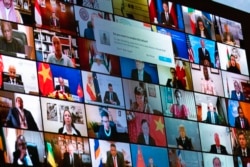 World leaders are shown on a screen as President Joe Biden speaks to the virtual Leaders Summit on Climate, from the East Room of the White House, Friday, April 23, 2021, in Washington. (AP Photo/Evan Vucci)