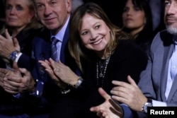 General Motors CEO Mary Barra applauds some of her company managers as they are introduced at a Chevrolet truck unveiling at the North American International Auto Show in Detroit, Michigan, Jan. 13, 2018.