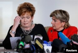 FILE - Beverly Young Nelson, left, reacts as she reads a statement to reporters with attorney Gloria Allred during a news conference announcing new allegations of sexual misconduct against Alabama Republican congressional candidate Roy Moore, in New York, Nov. 13, 2017.