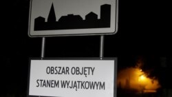 FILE - Road sign with "Area covered by a state of emergency" is seen near the Belarusian-Polish border in Nowosady, Poland, Oct. 12, 2021.
