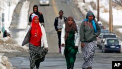 FILE - Students walk home from school in Lewiston, Maine, Jan. 26, 2016. Since February 2000, more than 5,000 Africans have come to Lewiston; now, many Somali shops, restaurants and mosques serve the city.