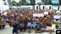 FILE - This photo made from Australia Broadcasting Corporation video taken Oct. 31, 2017, shows asylum-seekers protesting the possible closure of their detention center on Manus Island, Papua New Guinea.