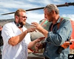 Co-writer/director Joe Carnahan reviews a scene with Liam Neeson on the set of The A-Team