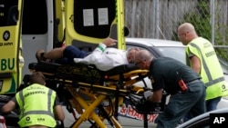 Ambulance staff take a man from outside a mosque in central Christchurch, New Zealand, Friday, March 15, 2019.