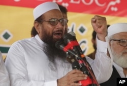 FILE - Hafiz Saeed, leader of Jamaat-ud-Dawa, addresses an anti-Indian rally in Lahore, Pakistan, Sept. 30, 2016.