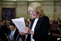 FILE - Former Venezuelan Chief Prosecutor Luisa Ortega shows documents that she claims prove that Venezuela's President Nicolas Maduro took bribes for the Brazilian construction company Odebrect, in Bogota, Colombia, April, 3, 2018.