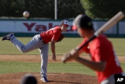 In this June 23, 2017 photo, pitcher Eric Pardinho throws a pitch during practice in Ibiuna, Brazil.