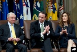 FILE - Attorney General Jeff Sessions, accompanied by Deputy Attorney General Rod Rosenstein and Associate Attorney General Rachel Brand, attend a summit at the Department of Justice in Washington, Feb. 2, 2018.
