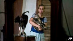 Grettel Montes de Oca Valdes, a professional dancer and founder of the group Cubans in Defense of Animals poses with cats in her home in Havana, Cuba, April. 4, 2019. A group of animal-lovers will march down one of Havana’s main thoroughfares Sunday calling for an end to animal cruelty in Cuba.