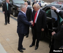 FILE - U.S. President Donald Trump is greeted by Defense Secretary James Mattis (L) prior to a swearing-in ceremony for Mattis at the Pentagon in Washington, Jan. 27, 2017.