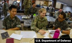 FILE - A U.S. Army captain learns a few Korean terms from two Korean Army soldiers during the 2016 Ulchi Freedom Guardian exercises in Yongin, South Korea, Aug. 25, 2016.