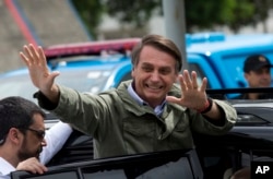 FILE - Jair Bolsonaro, presidential candidate with the Social Liberal Party, waves after voting in the presidential runoff election in Rio de Janeiro, Brazil, Oct. 28, 2018.