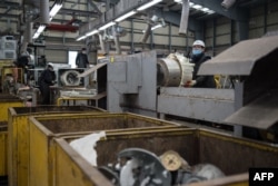 FILE - A worker disassembles a discarded washing machine at the Metropolitan Electronics Recycling Center in Yongin, south of Seoul, South Korea, Jan. 13, 2017. Electronic waste is rising sharply across Asia, with serious consequences for human health and the environment, according to a U.N. study released in January 2017.
