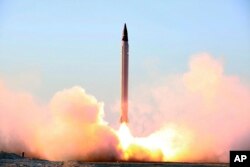 This picture released by the official website of the Iranian Defense Ministry on Sunday, Oct. 11, 2015, claims to show the launching of an Emad long-range ballistic surface-to-surface missile in an undisclosed location. Iran successfully test fired a new