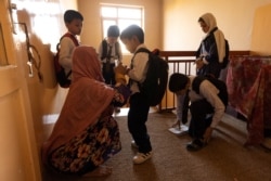 Golshan, a childcare worker, gets the children ready for school at the orphanage in Kabul, Afghanistan, October 12, 2021. REUTERS/Jorge Silva