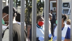 In this April 2, 2020, file photo, medical workers prepare to test people for COVID-19 at a testing clinic in Khayelitsha, Cape Town, South Africa.