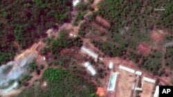 FILE - This Wednesday, May 23, 2018 satellite file image provided by DigitalGlobe, shows the Punggye-ri test site in North Korea. North Korea has carried out what it says is the demolition of its nuclear test site in the presence of foreign reporters.