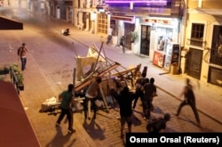 FILE - Anti-government protesters clash with riot police at Taksim in central Istanbul, July 20, 2013.