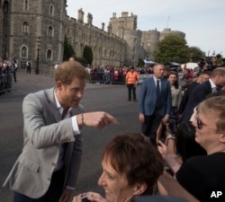Britain's Prince Harry, left, and Prince William greet well-wishers outside Windsor castle, in Windsor, England, May 18, 2018, ahead of Prince Harry's wedding to Meghan Markle on May 19.