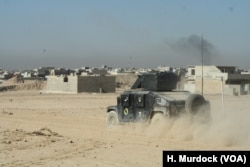 An Iraqi Army vehicle races to the front in Mosul, Iraq, Nov. 19, 2016.
