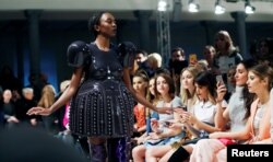 A model presents a creation by Marina Hoermanseder on the sidelines of the Berlin Fashion Week Autumn/Winter 2017/2018 in Berlin, Germany Jan. 19, 2017.
