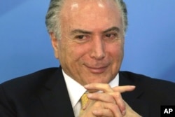 Brazil's President Michel Temer smiles during a meeting with businessmen and trade unions at the Planalto presidential palace in Brasilia, Brazil, Sept. 12, 2017.