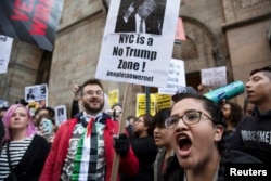 FILE - Protesters demonstrate against Republican U.S. presidential candidate Donald Trump in midtown Manhattan in New York City, April 14, 2016.