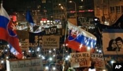 FILE - People flash the lights of their mobile phones as they celebrate the resignation of Prime Minister Robert Fico and his government during a rally in Bratislava, Slovakia, March 16, 2018.