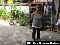 Elisabeth Pacaldo, one of millions of Filipino women who have moved to cities and other countries to find jobs, poses for a picture at her employer's office in Manila, Philippines, March 15, 2018.
