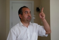Mahmut Tevekkul, an ethnic Uyghur who fled from China to Turkey, gestures as he talks to The Associated Press in Istanbul, Wednesday, June 2, 2021. (AP Photo/Mehmet Guzel)