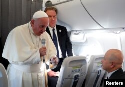 Pope Francis speaks with reporters on his flight back from Tallinn, Estonia, after the final leg of his visit to the Baltic states, Sept. 25, 2018.