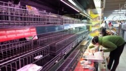 Customers search for food on near empty shelves that were depleted due to panic buying amid the coronavirus disease (COVID-19) pandemic in Ho Chi Minh City, Vietnam August 21, 2021. REUTERS/Stringer NO RESALES NO ARCHIVES