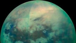 This Nov. 13, 2015 composite image made available by NASA shows an infrared view of Saturn's moon, Titan, as seen by the Cassini spacecraft. The near-infrared wavelengths in this image allow the cameras to penetrate the haze and reveal the moon's surface.