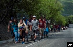 Honduras migrants walk to the U.S as they approach Zacapa, about 70 miles northeast of Guatemala City, Oct. 24, 2018.
