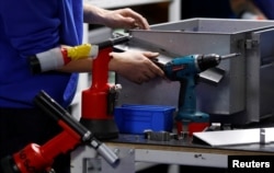 A worker assembles metal components at the Mec Com Ltd factory near Stafford, central England, Dec. 15, 2016.