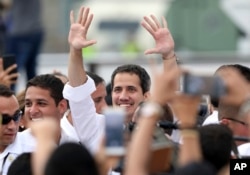 Venezuela's self-proclaimed interim president Juan Guaido, center, arrives at the Venezuela Aid Live concert on the Colombian side of the Tienditas International Bridge near Cucuta, Colombia, on the border with Venezuela, Feb. 22, 2019.