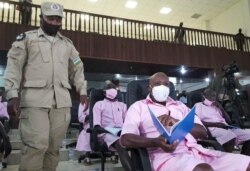 FILE - Paul Rusesabagina, portrayed as a hero in a Hollywood movie about Rwanda's 1994 genocide, sits inside the courtroom in Kigali, Rwanda, Feb. 17, 2021.
